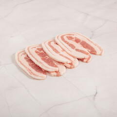 Sliced pork belly meat arranged on white marble surface for freshness – High Resolution Raw Meat Image for Food Industry or Food Packaging