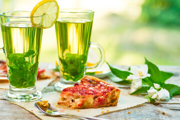 Enjoying Refreshing Herbal Drinks and a Delicious Fruit Tart on a Bright Sunny Day