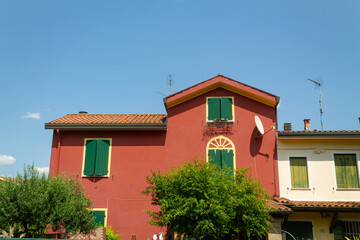 House with shutters in the countryside in Italy in the summer in clear and hot weather