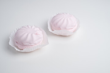 Pink marshmallow - sweet dessert close-up on a light background.
