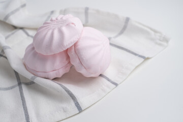 Pink marshmallow - sweet dessert close-up on a light background.