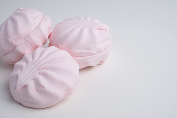 Pink marshmallow - sweet dessert close-up on a light background.