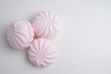 Pink marshmallow - sweet dessert close-up on a light background.