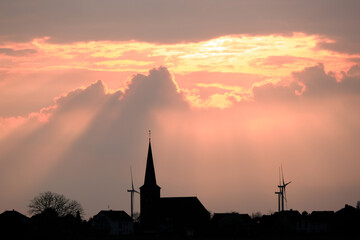 Obraz premium A church with two windmills in the background