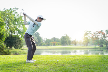 Asian amateur golfer is performing a tee off swing, man playing golf in golf course.