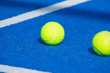 blue paddle tennis court, two ball on surface