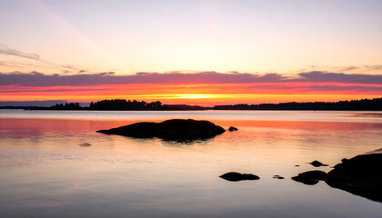 Peaceful sunset over still waters with golden reflections and soft glowing sky
