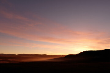 Obraz premium breathtaking view of mount grigori illuminated by ultrabright neon lights during stunning sunset