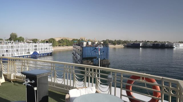 View of cruise boats at Kom Ombo Temple from a cruise boat sailing on the Nile River near Aswan, Aswan, Egypt, Africa