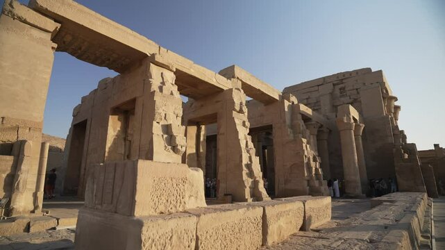 View of visitors at Kom Ombo Temple on the Nile River near Aswan during golden hour, Aswan, Egypt, Africa