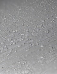Close-up of brushed silver, showing metallic grain , shiny, oxidized, metal