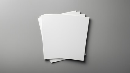 Blank white paper sheets stacked on gray background for design use