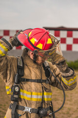 Brave firefighter of Egyptian origin putting on and adjusting his helmet, ready to go put out a fire.