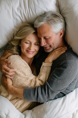 Senior couple hugging in bed, cozy and emotional moment