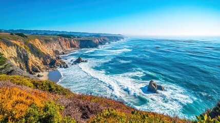 Obraz premium Stunning California coastline with turquoise ocean, rocky cliffs, and blue sky.