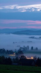 Fototapeta premium Misty Evening in the Countryside with Soft Glow of Distant Lights