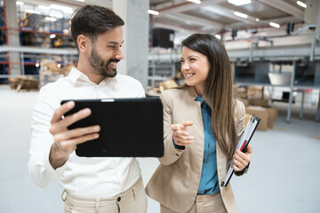 Employees engage in a lively discussion with tablets, exemplifying teamwork and the exchange of innovative ideas.