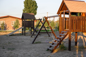 Children's outdoor play complex. Children's playground with swings and stairs