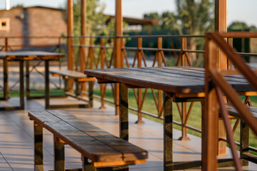 Cozy wooden balcony with a bench and a view of nature
