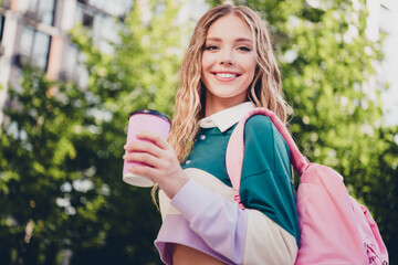 Fototapeta premium Photo of pretty young girl carry bag drink coffee wear top free time city center outdoors