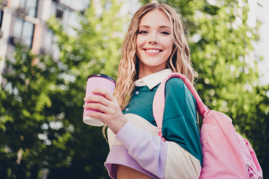 Photo of pretty young girl carry bag drink coffee wear top free time city center outdoors