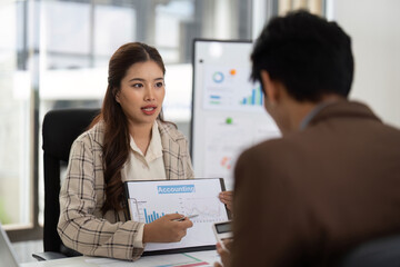 Accounting Insights and Data Presentation. Businesswoman explaining financial charts to her colleague.