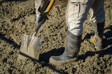 Closeup of construction worker with shovel
