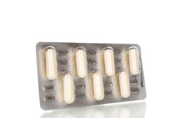 Medical pills in blister packaging, close-up, isolated on white background.