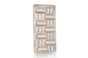 Medical pills in blister packaging, close-up, isolated on white background.