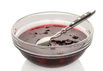 Cherry jam in a glass plate  isolated on a white background, close-up.