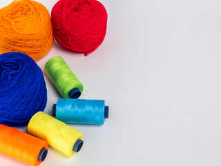 Colorful Yarn Balls and Thread Spools on a Bright White Surface