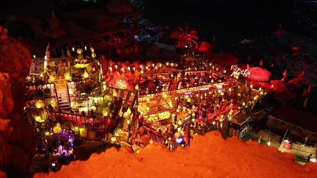 Night market vibes exotic lanterns glow as people gather at cliffside beach lounge Farsha in Sharm El Sheikh vibrant energy meets cozy decor in this magical Middle Eastern nightlife escape
