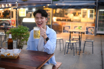Joyful Beer Moment at Night Market, A Cheerful Young Man Laughing with a Cold Beer in Hand