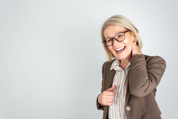 Photo of tired upset mature lady wear business clothes arm neck having pain isolated grey color background