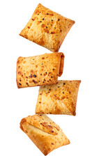 Fototapeta premium falling fried stuffed roti parcels isolated on white background 