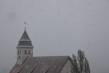A church steeple covered in snow