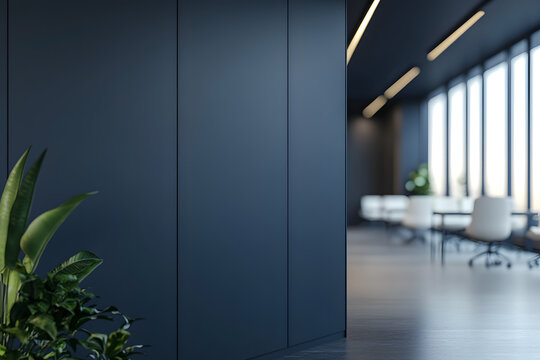 Blank dark wall mockup in modern office interior with blurred meeting room and white chairs in background with copyspace for branding or signage.