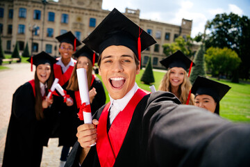 Excited graduates celebrating their academic success on campus during a sunny day in the city