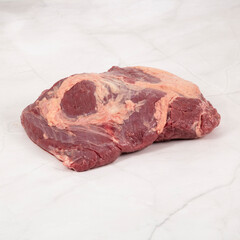 Raw chuck roast beef cut with marbling on a white surface – High Resolution Raw Meat Image for Food Industry or Food Packaging