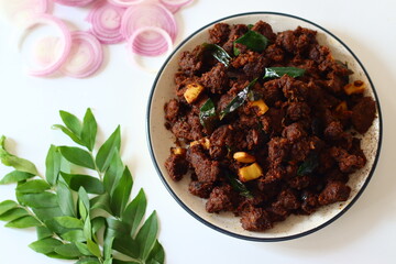Kerala Beef Fry. A flavorful South Indian dish made by marinating beef with spices, slow-cooking it with onions
