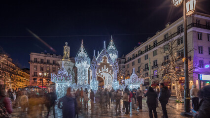 Night timelapse hyperlapse of Christmas decorations with illuminated castle on Luis de Camoes...