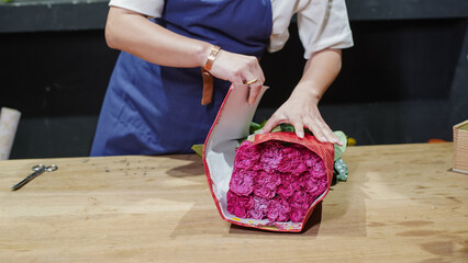 Florist unpacking a package of roses. Small business.  Close-Up.  Soft focus.