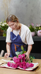 Florist unpacking a package of roses. Small business.  Close-Up.  Soft focus.