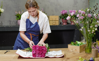 Florist unpacking a package of roses. Small business.  Close-Up.  Soft focus.