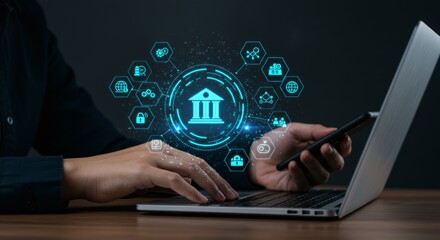 Financial technology concept.  Hands on laptop and phone with digital banking icons