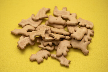 closeup of animal crackers on yellow background