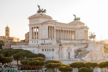 Obraz premium Stunning golden hour view of Altare della Patria in Rome, Italy. Majestic neoclassical architecture lit by soft evening sunlight