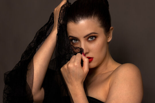 Woman with professional makup headshot in studio with grey background