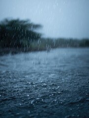 Heavy monsoon rains falling on a flooded landscape