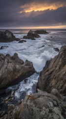 Dramatic sunset over pacific ocean rocky coastline waves crashing